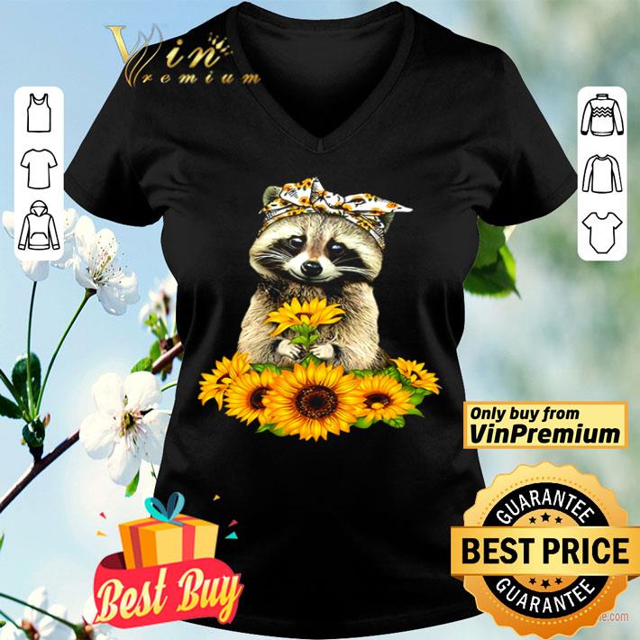 Raccoon holding sunflower shirt